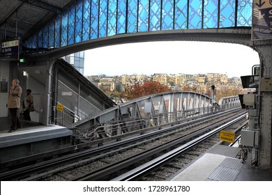 Paris.10,November ,2011 :  View  showing railway tracks and elevated  colorful  station platform of  Metropolitan Rail System  above ground with  residential buildings in background Paris, France  - Shutterstock ID 1728961780