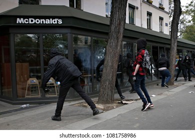 Paris,France May 1,2018.Masked Youth Protesters Attack A Shop Front While Clashing With French Police Force During A March For The Annual May Day Workers' Rally.