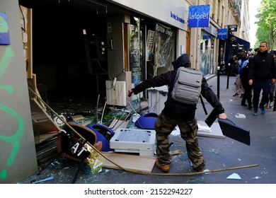 Paris,France May 1,2022.Masked Youth Protesters Attack A Shop Front While Clashing With French Police Force During A March For The Annual May Day Workers' Rally.