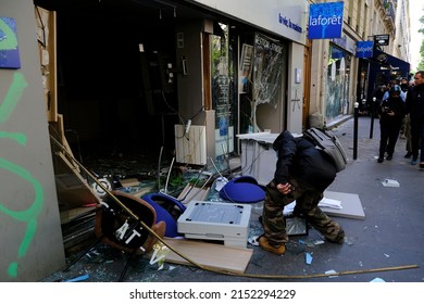 Paris,France May 1,2022.Masked Youth Protesters Attack A Shop Front While Clashing With French Police Force During A March For The Annual May Day Workers' Rally.