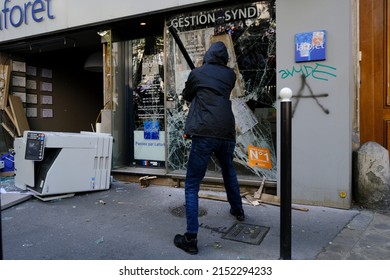 Paris,France May 1,2022.Masked Youth Protesters Attack A Shop Front While Clashing With French Police Force During A March For The Annual May Day Workers' Rally.