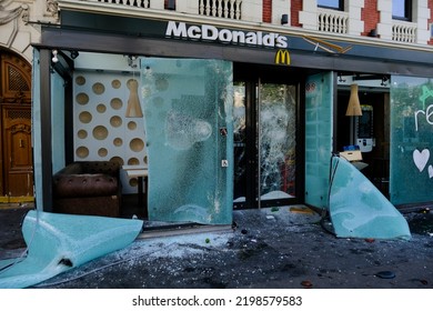 Paris,France May 1,2022.Masked Youth Protesters Attack A Shop Front While Clashing With French Police Force During A March For The Annual May Day Workers' Rally.