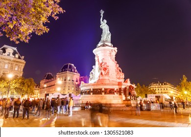 PARIS/FRANCE, October 01 2018: Place De La République In Night With Colorful Lit Monument/Statue And Crowds Of People Rushing By