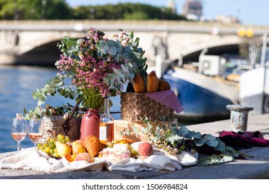 Paris/France - September 8 2019: Romantic Picnic For Two On The Quay Of Seine River In Paris. Parisien Elegancy And Chic. Traditional French Croissants, Cheese, Fruits And French Wine. 