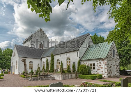 Parishioners leaving the old white norra vrams church in the swedish village of Billesholm.