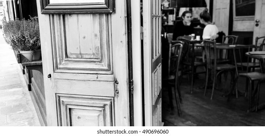 Parisian cafe. Blurred interior with young couple. Romantic Paris concept. Black and white. - Powered by Shutterstock