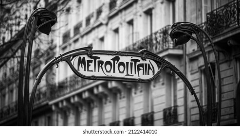 Parisian metropolitan (metro, subway) sign in a street during the day. Typical house in the background. Old times, vintage, nostalgia concept. Historic black and white photo. Paris, France.  - Shutterstock ID 2122414010