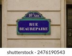 parisian street name sign on haussmannian facade