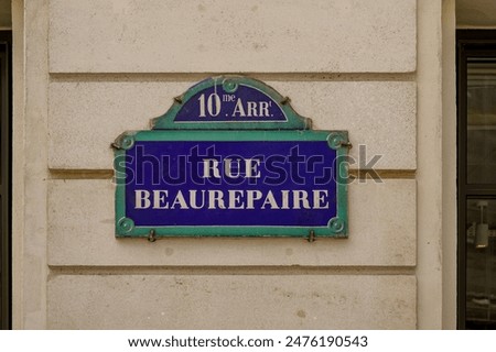 parisian street name sign on haussmannian facade