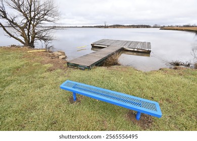 Park bench by a wooden dock - Powered by Shutterstock