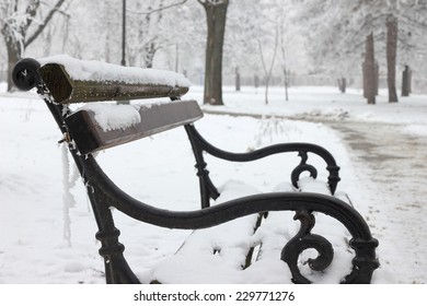 Park bench covered with snow