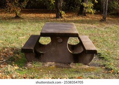 Park bench in grass area. - Powered by Shutterstock