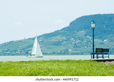 park bench and old style iron lamp on the beach - Powered by Shutterstock