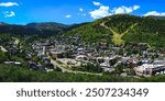 Park City Mountain Ski Resort and historic downtown summer landscape with landmark buildings in Utah, panoramic scenery with green trees of the Wasatch Mountains