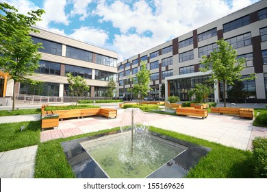 Park with fountains and benches in front of the Business Center