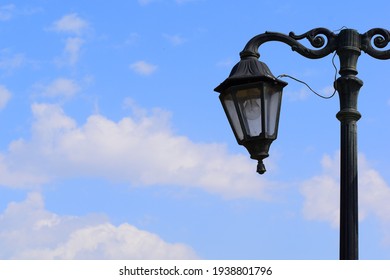 Park lamp having cloudy background. Blue sky.