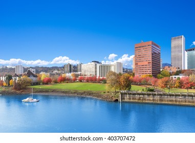 park near tranquil water with cityscape and skyline in portland