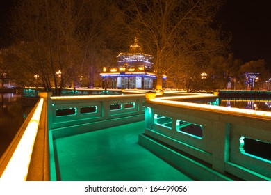 Park at night with illuminated led lights along the path around the pond at the Potala Square in Lhasa. Tibet 2013.