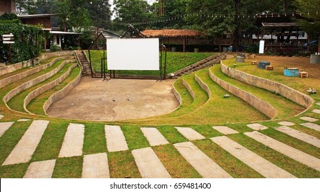 park outdoor opening cinema white screen theatre or theater in summer green grass lawn garden