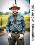 A park ranger is outdoors displaying dedication to conservation and protecting nature