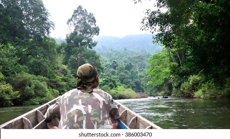 Park Ranger Patrol Along The River By Boat In Tropical Forest