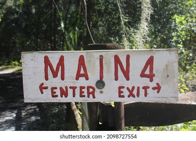 Park Trail Enter Exit Sign With Red Lettering On White Wood