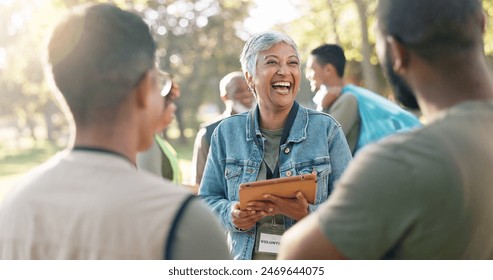 Park, woman and laugh planning with tablet for volunteer teamwork, community project or nature sustainability. Humanitarian, recycling or senior leader in charity service or NGO for pollution cleanup - Powered by Shutterstock