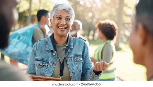 Park, woman and volunteers discussion with tablet for support, community project or nature sustainability. Humanitarian, recycling or senior leader in charity service and NGO for pollution cleanup - Powered by Shutterstock