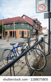 Parked Bicycles With Building Behind At City Street, Hamar, Hedmark, Norway