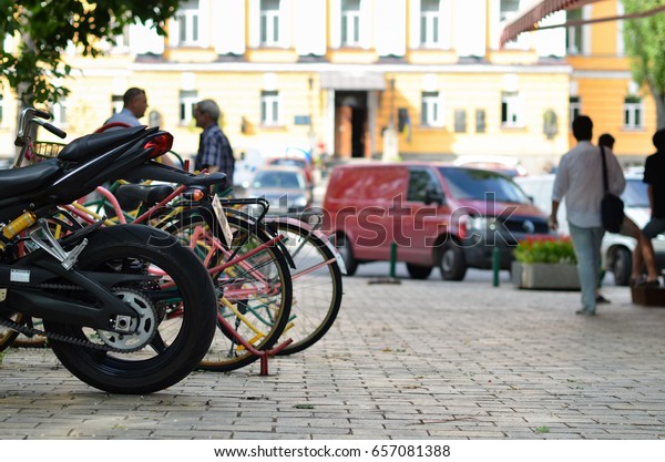 parked bicycles and\
motorcycles in park