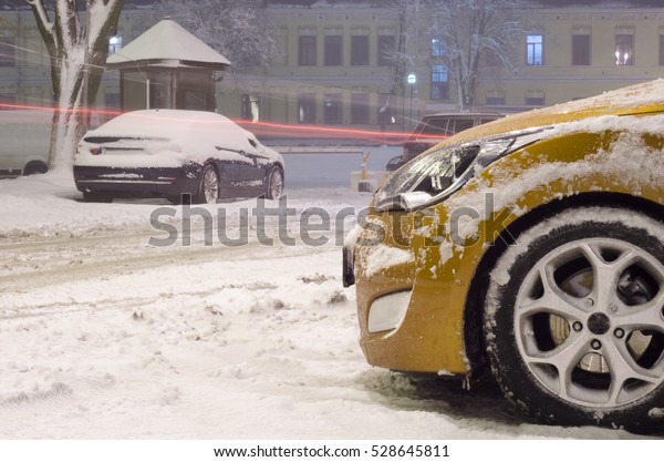 parked car in blizzard\
night