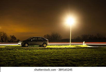 Parked Car At Night With Light Trails