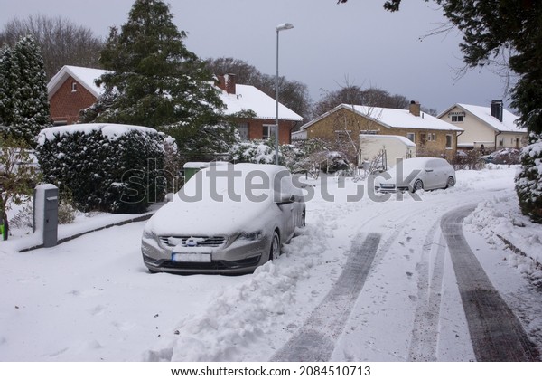 Parked car in street during winter winter after\
heavy snowfall