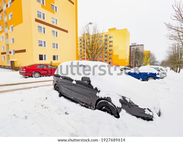 Parked car trapped in huge snow cover. The\
car was covered with snow. Car under the\
snow