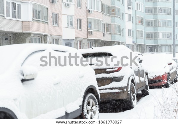 parked\
car in the yard covered with snow. heavy\
snowfall