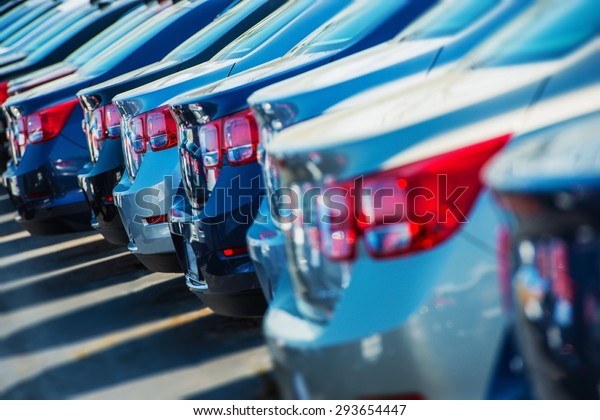 Parked Cars on a Lot. Row of New Cars on\
the Car Dealer Parking Lot. Cars Market\
Theme.
