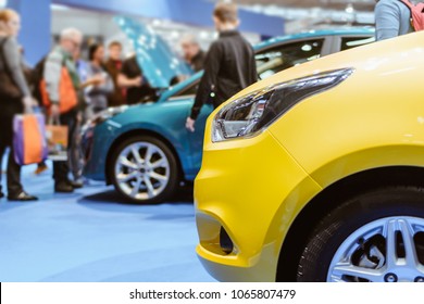 Parked Colorful Brand New Cars. Car Dealership For Sale In Fair Event. Gathering Of People For Autos Entertainment Or Commercial Activities. Transportation Industry Concept With Person In Photo.