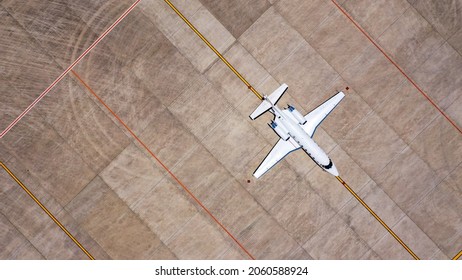 Parked Expensive Private Airplane On Concrete Ground Of Airport, Aerial. Small Business Jet Parked On The Runaway