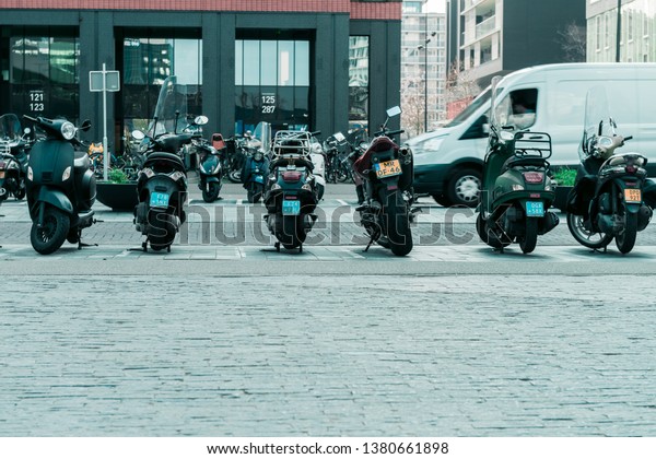 Parked motorbikes and\
scooters, Modern office buildings in Amsterdam, Gustav Mahlerlaan\
Amsterdam 2019