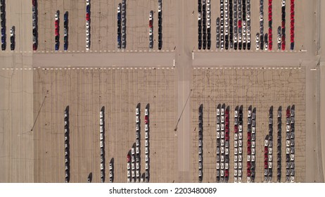 Parked New Cars At The Car Automotive Plant Manufacturer Lot. Electric Hybrid Cars Vehicle Factory. Aerial. Almost Empty Stock. Broken Supply Chain And Chip Shortage Lead To Car Shortage Availability