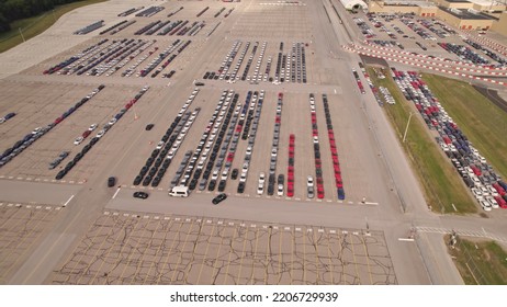 Parked New Cars At The Car Automotive Plant Manufacturer Lot. Electric Hybrid Cars Vehicle Factory. Aerial. Almost Empty Stock. Broken Supply Chain And Chip Shortage Lead To Car Shortage Availability