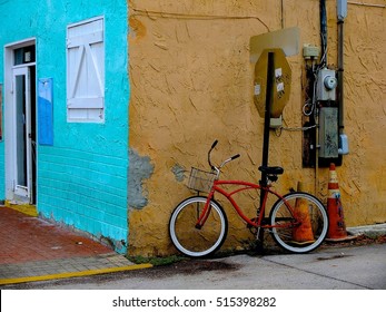 Parked Red Bike On The Corner Of Colorful Painted Building Walls In Key West, Florida.