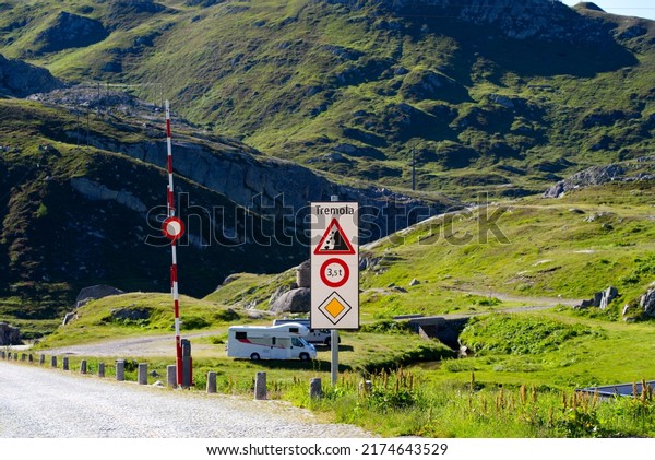 Parked white recreation\
vehicle parked at of old Tremola pass road at Gotthard Pass on a\
sunny summer day. Photo taken June 25th, 2022, Gotthard Pass,\
Switzerland.