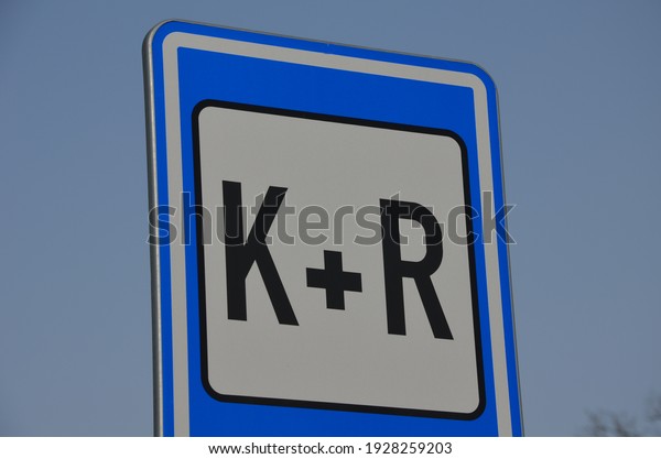 parking along the\
sidewalk with a sign car and ride. serves to combine car and public\
transport. an informative blue traffic sign confirms this method of\
parking the vehicle