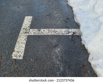 A Parking Area Where Half The Parking Spot Is Covered By Snow. It's A Parallel Parking Spot In The Road.