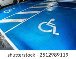 A parking lot with a blue handicap parking sign