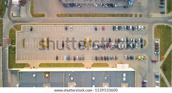 Parking lot with cars above top view. Colorful half\
empty parking lot
