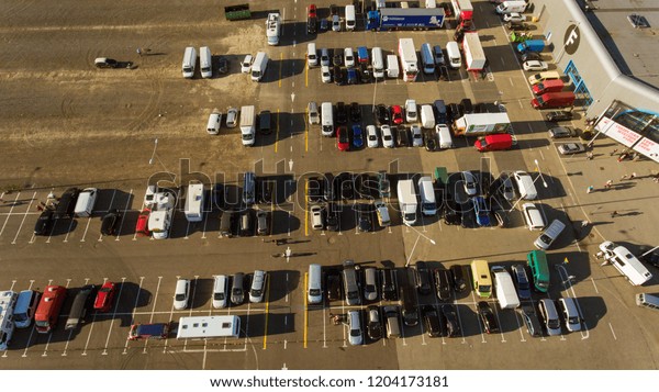 Parking lot with cars aerial\
view.