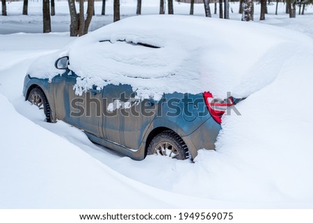 Parking of cars covered with snow. Heavy snowfall covered the road. Car in the snow