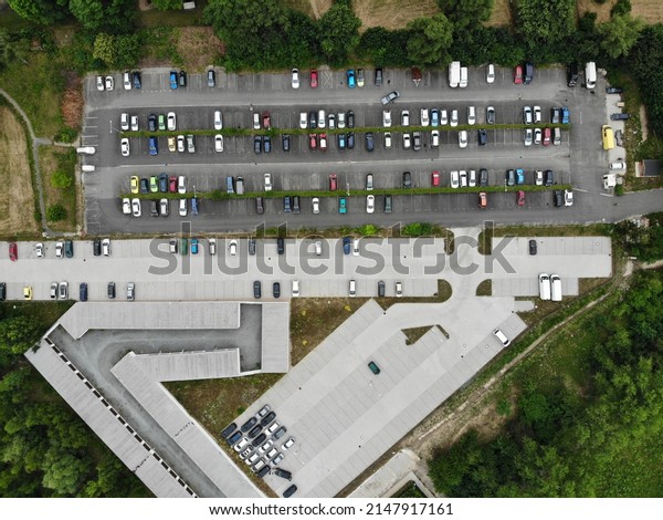 Parking lot\
with cars. Drone view of a busy car\
park.